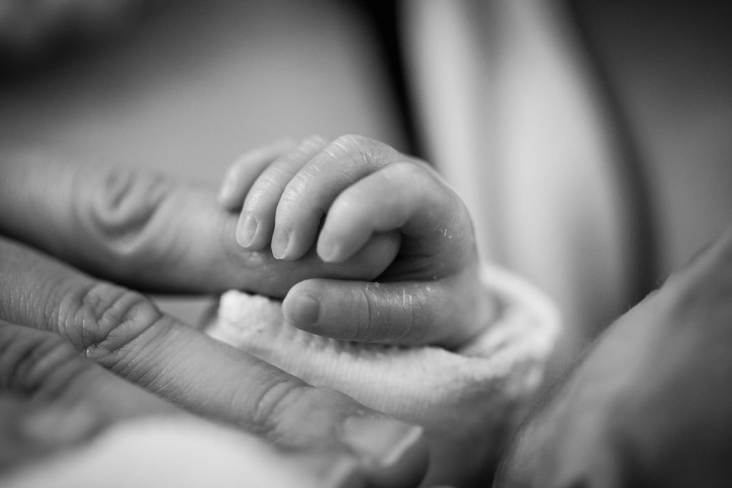 https://www.pexels.com/photo/grayscale-photography-of-baby-holding-finger-208189/