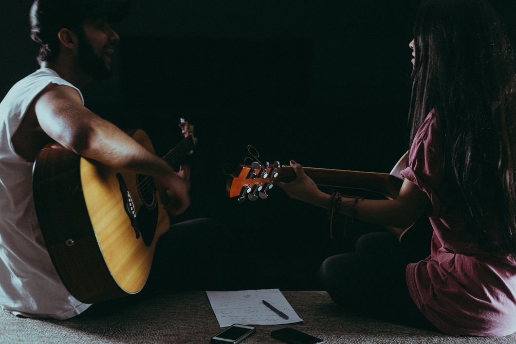 https://www.pexels.com/photo/man-and-woman-playing-guitar-1164763/