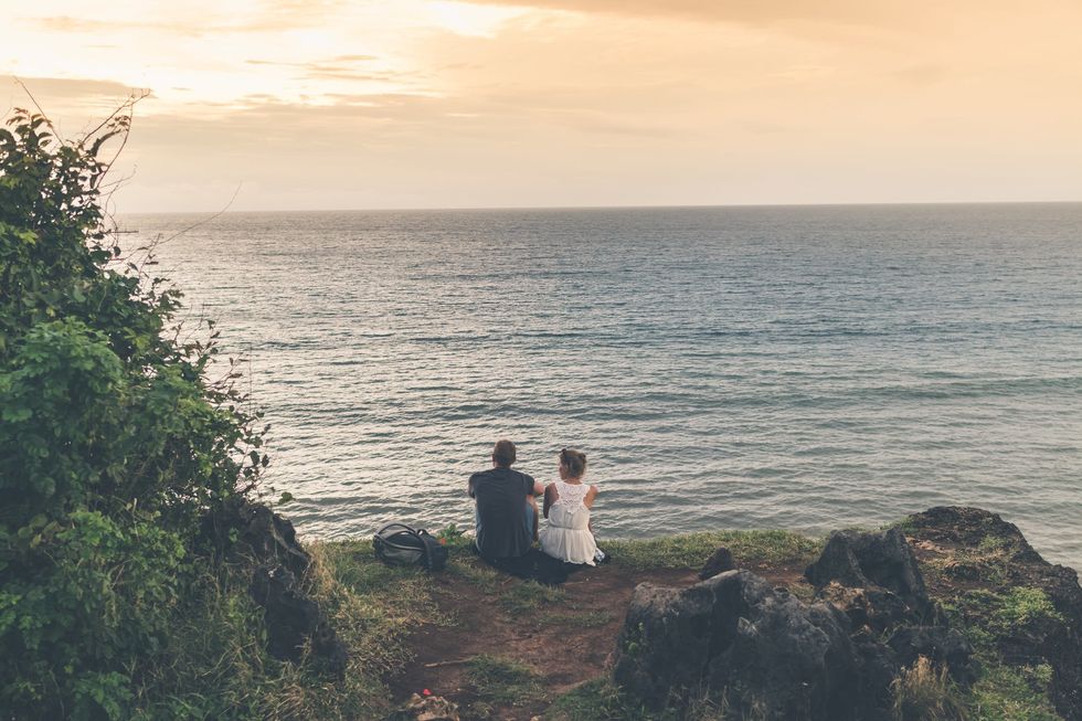 https://www.pexels.com/photo/man-and-woman-sitting-near-body-of-water-918315/