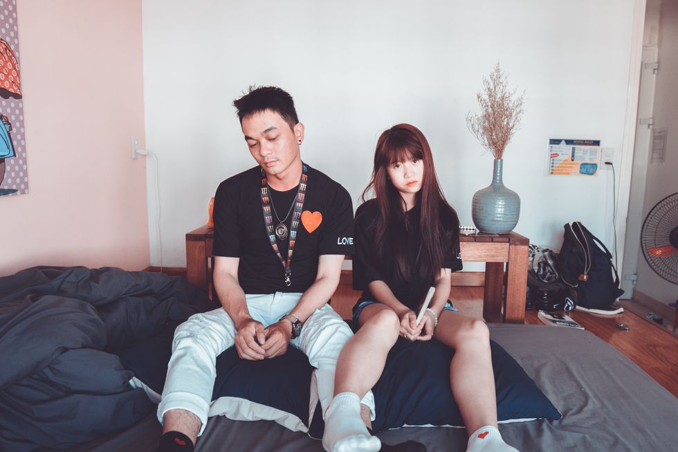 https://www.pexels.com/photo/man-and-woman-wearing-black-shirts-sitting-on-bed-1057025/