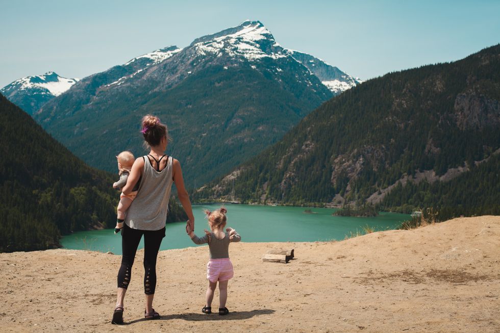 https://www.pexels.com/photo/mother-and-children-walks-near-body-of-water-1157399/