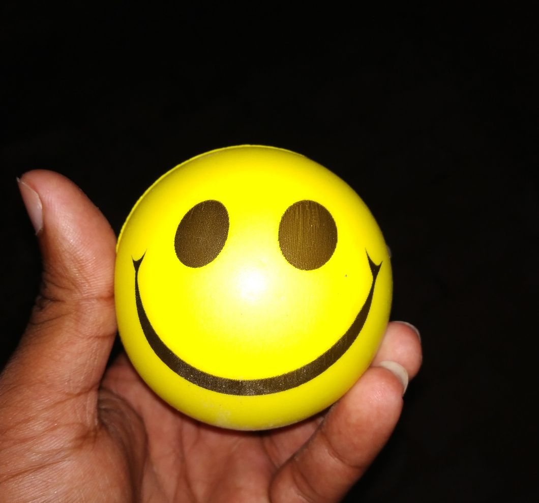 https://www.pexels.com/photo/person-holding-emoticon-ball-1579371/