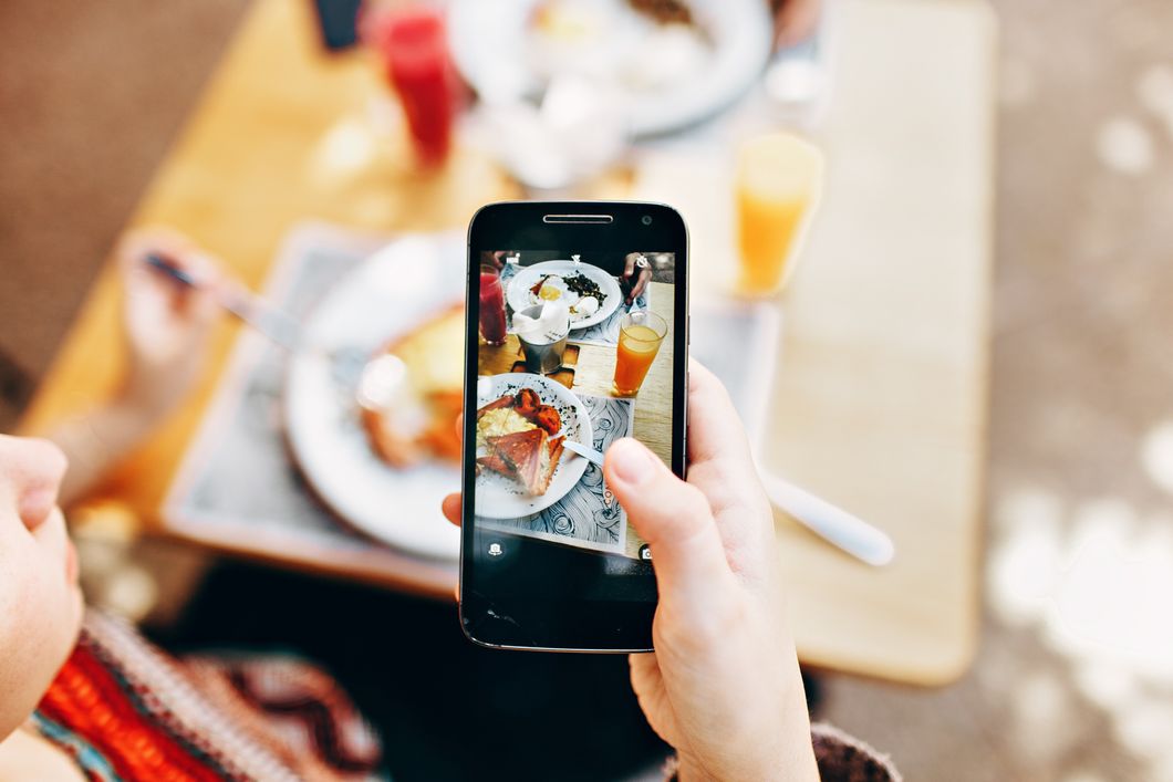 https://www.pexels.com/photo/person-holding-phone-taking-picture-of-served-food-693267/
