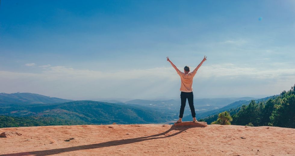 https://www.pexels.com/photo/person-in-beige-top-on-mountain-cliff-1134188/