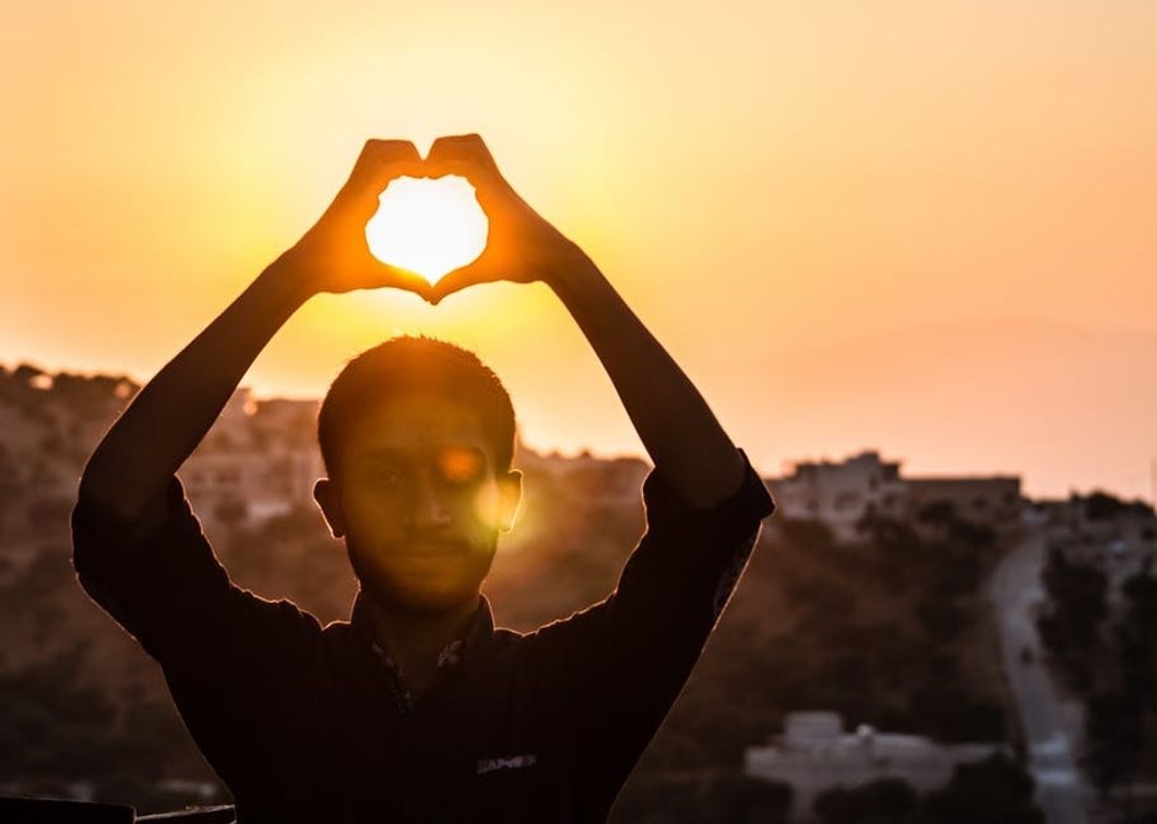 https://www.pexels.com/photo/person-making-heart-shape-with-his-hand-during-sunset-705209/