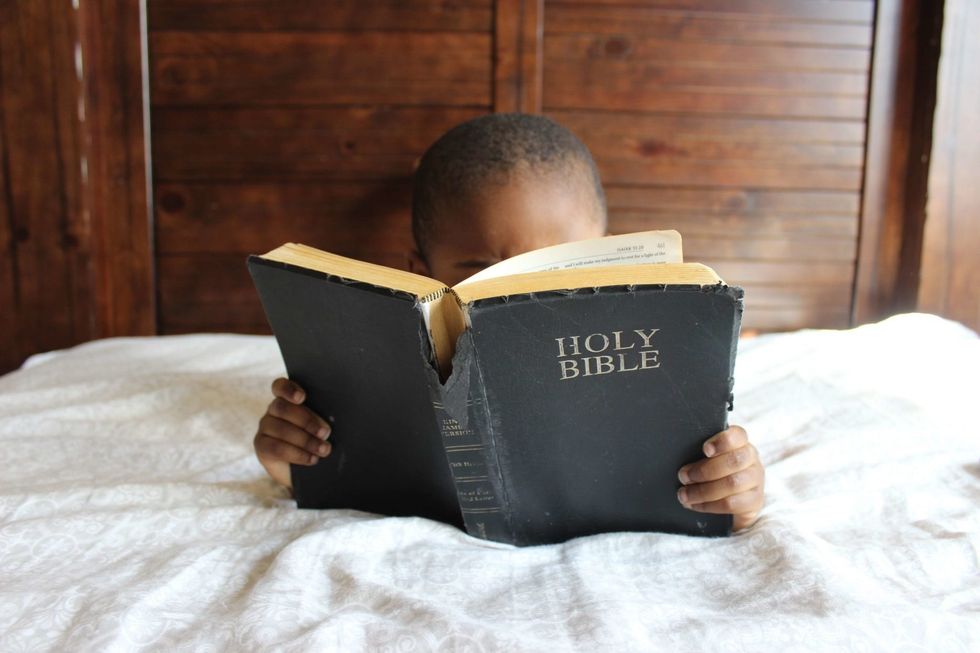 https://www.pexels.com/photo/photo-of-child-reading-holy-bible-935944/
