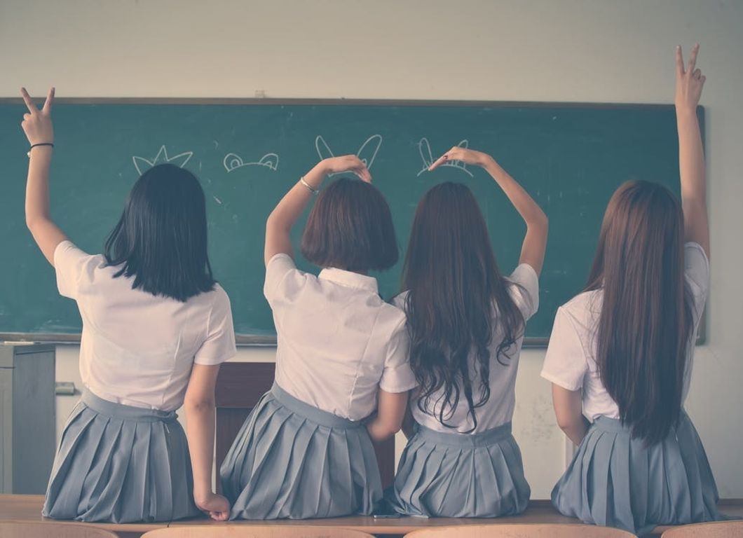 https://www.pexels.com/photo/photo-of-four-girls-wearing-school-uniform-doing-hand-signs-710743/