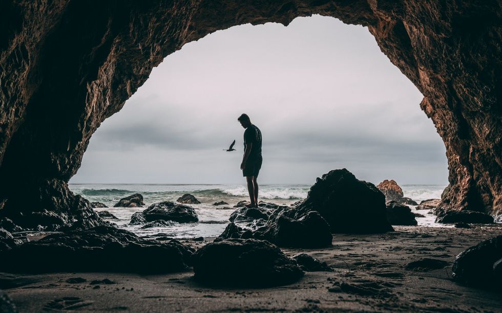 https://www.pexels.com/photo/photo-of-man-standing-on-rock-near-seashore-1142948/