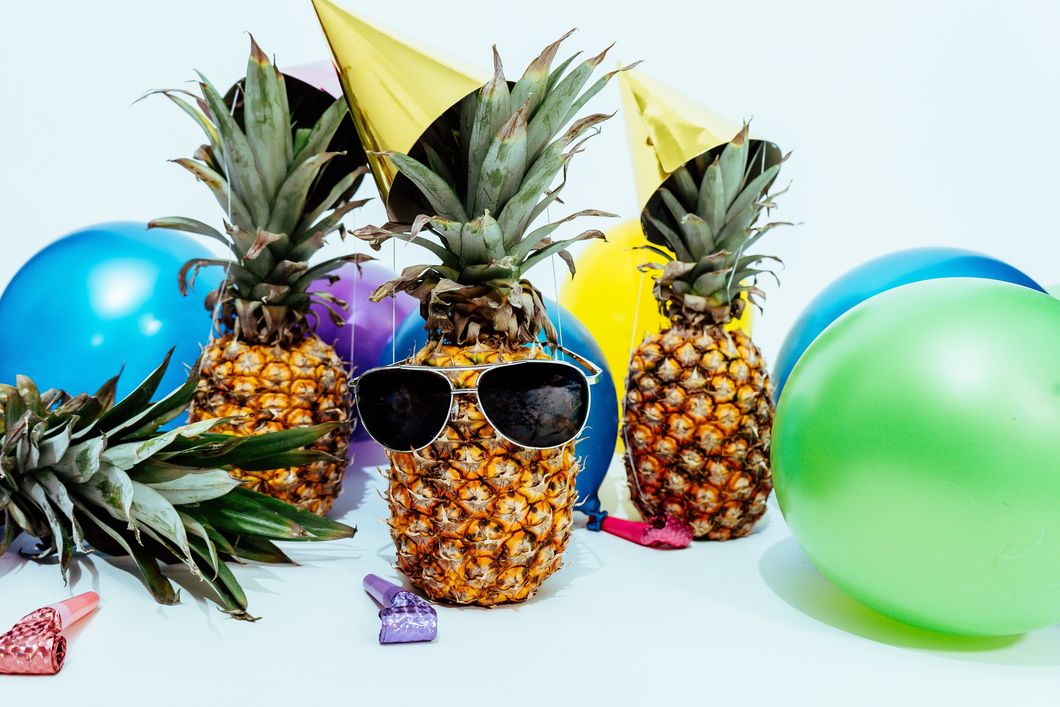 https://www.pexels.com/photo/photo-of-three-pineapples-surrounded-by-balloons-1071882/