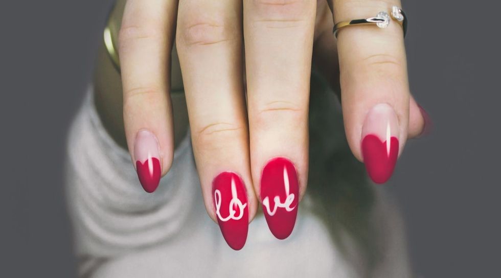 https://www.pexels.com/photo/red-and-white-manicure-with-love-print-887352/