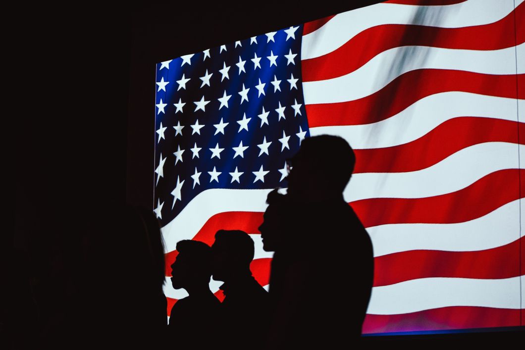 https://www.pexels.com/photo/silhouette-of-four-person-with-flag-of-united-states-background-1046398/