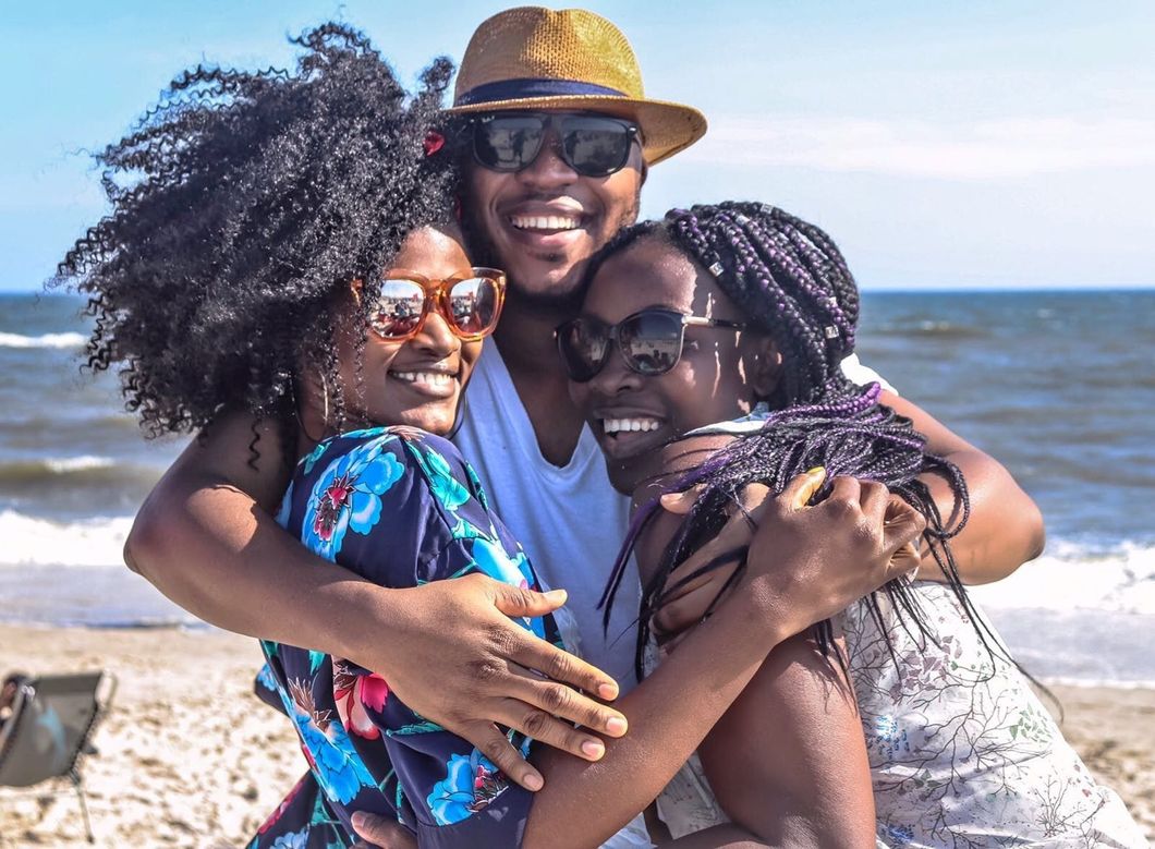 https://www.pexels.com/photo/two-women-with-man-hugging-by-the-sea-936018/