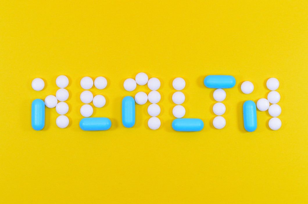 https://www.pexels.com/photo/white-and-blue-health-pill-and-tablet-letter-cutout-on-yellow-surface-806427/
