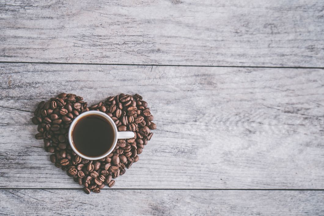 https://www.pexels.com/photo/white-ceramic-mug-filled-with-brown-liquid-on-heart-shaped-coffee-beans-867470/