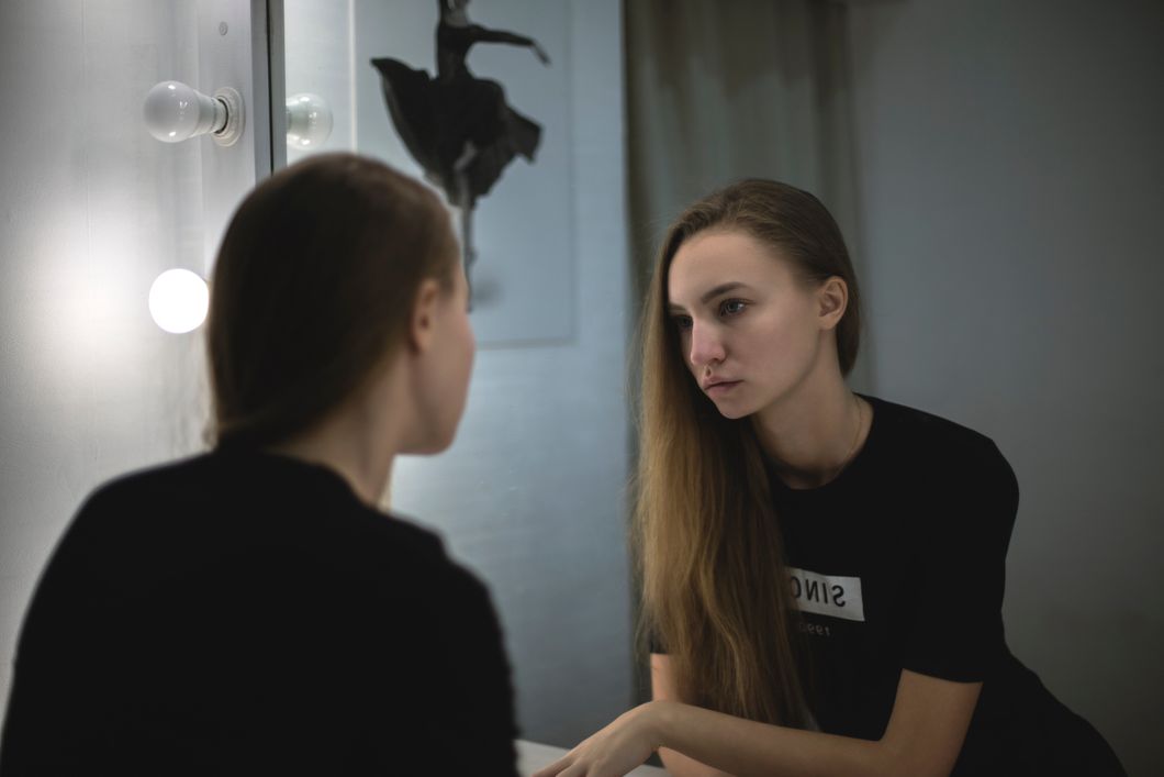 https://www.pexels.com/photo/woman-in-black-shirt-facing-mirror-211024/