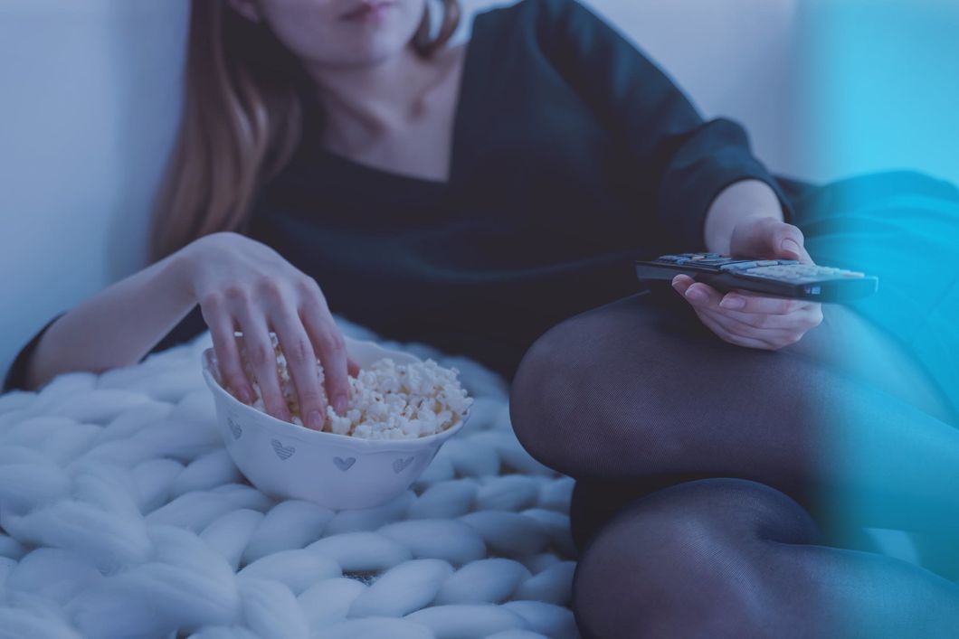 https://www.pexels.com/photo/woman-in-white-bed-holding-remote-control-while-eating-popcorn-1040158/