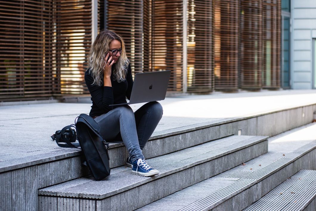 https://www.pexels.com/photo/woman-sitting-on-stairs-while-using-laptop-1438075/