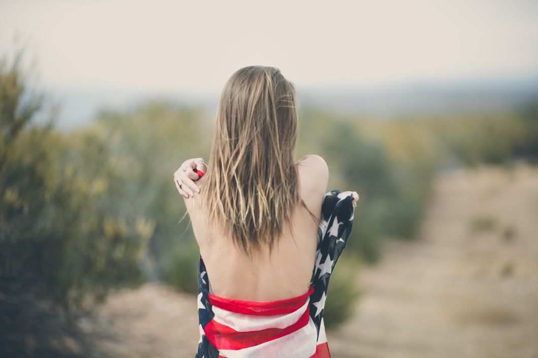 https://www.pexels.com/photo/woman-strapping-her-body-of-american-flag-113709/