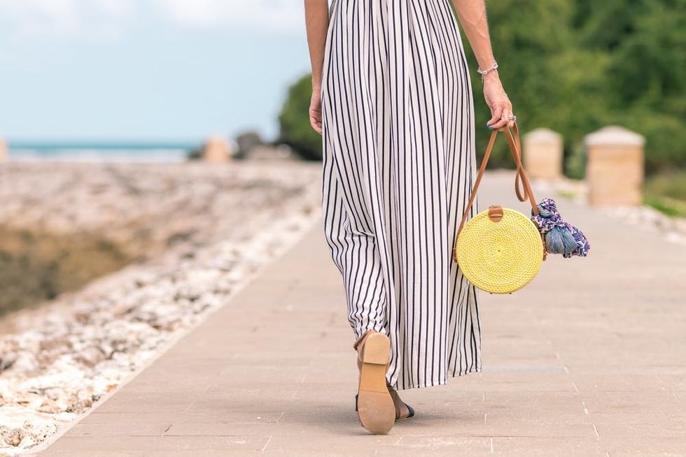 https://www.pexels.com/photo/woman-wearing-black-and-white-striped-maxi-skirt-holding-brown-bag-1100790/