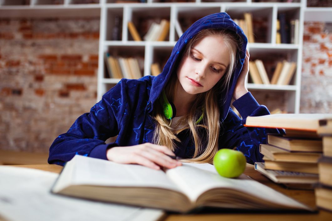 https://www.pexels.com/photo/woman-wearing-blue-jacket-sitting-on-chair-near-table-reading-books-1326947/