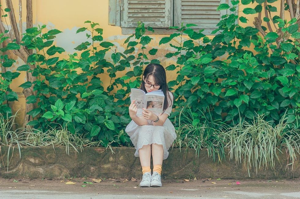 https://www.pexels.com/photo/woman-wearing-white-dress-reading-book-1196338/