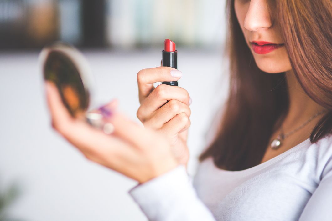 https://www.pexels.com/photo/woman-with-brown-hair-doing-lipstick-and-holding-little-mirror-6393/