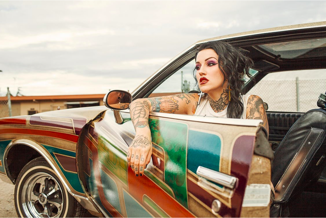 https://www.pexels.com/photo/woman-with-white-tank-top-inside-classic-multicolored-car-807688/