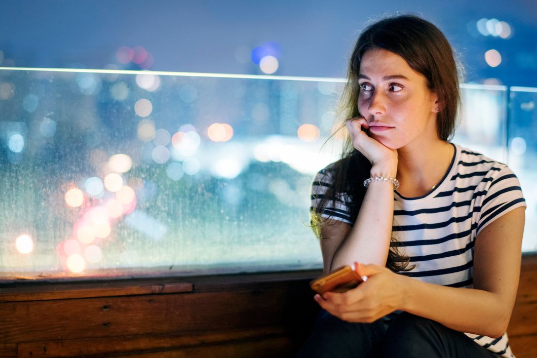 https://www.rawpixel.com/image/384318/unhappy-young-woman-holding-smartphone-evening-cityscape