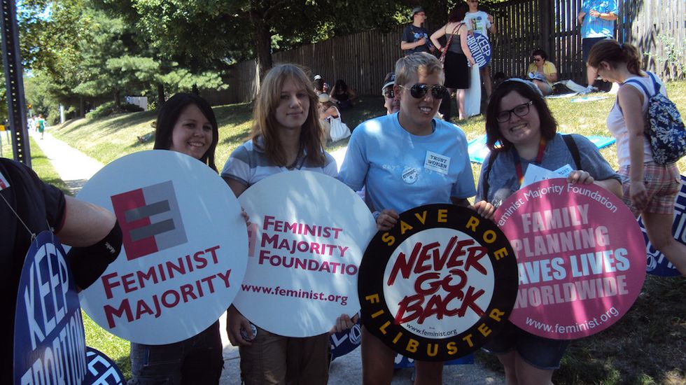 Uh, You Can Raise A Feminist Protest Sign WHILE Raising A Family, Too