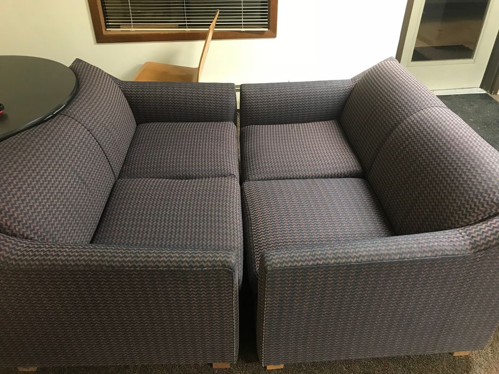 Two Old Men Sitting In A Boat Couch