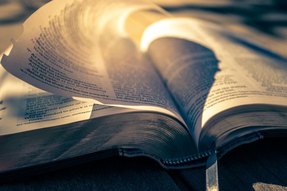 inspirational pages of bible reflecting in sunlight