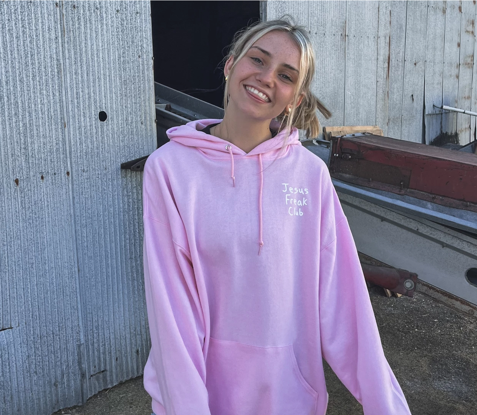 Jesus Freak Club pink hoodie on female model