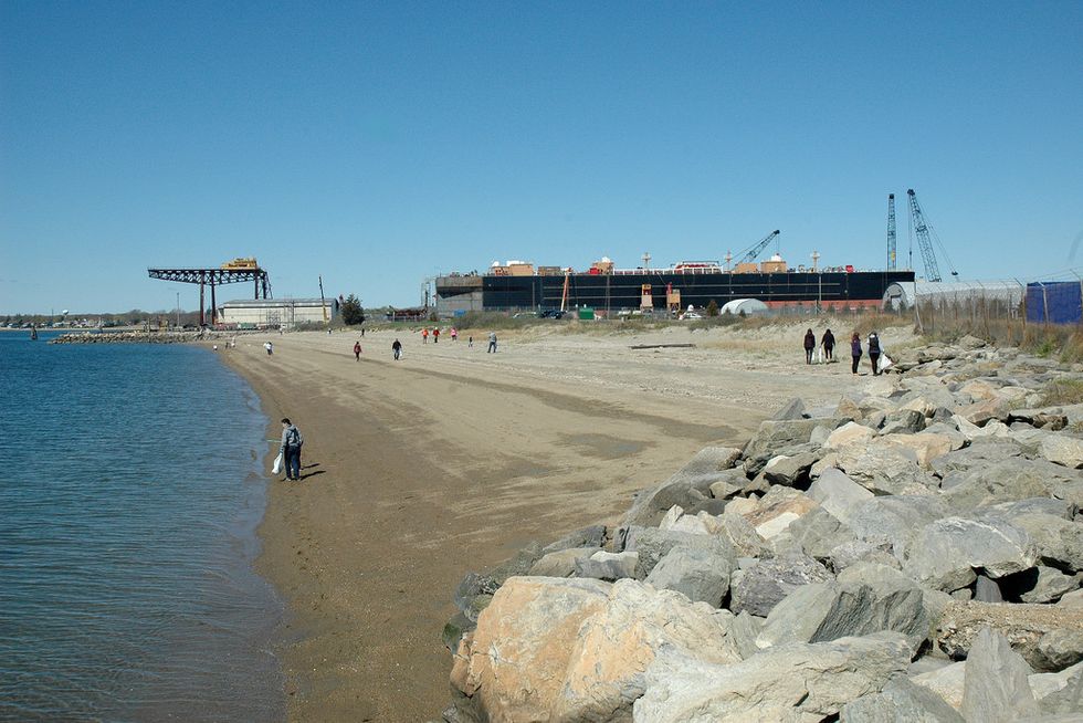 Kid taking things out of a landfill of trash