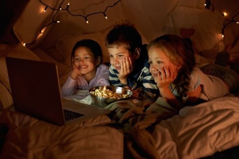 kids watching movies in a fort