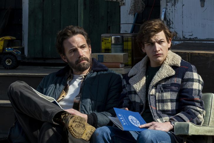​(Left to right) Ben Affleck as Uncle Charlie and Tye Sheridan as Jr sit together on a bench during a scene from Amazon Studios' "Tender Bar."\
