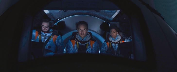 ​Left to right: John Bradley (as KC Houseman), Patrick Wilson (as Brian Harper) and Halle Berry (as Jocinda Fowler) sit in a cockpit during a scene from sci-fi epic "Moonfall." 