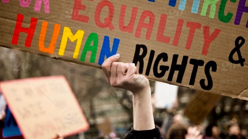 LGBT pride holding up humans rights sign