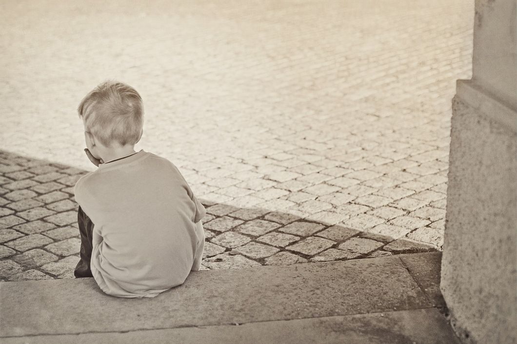 Little boy sitting on steps
