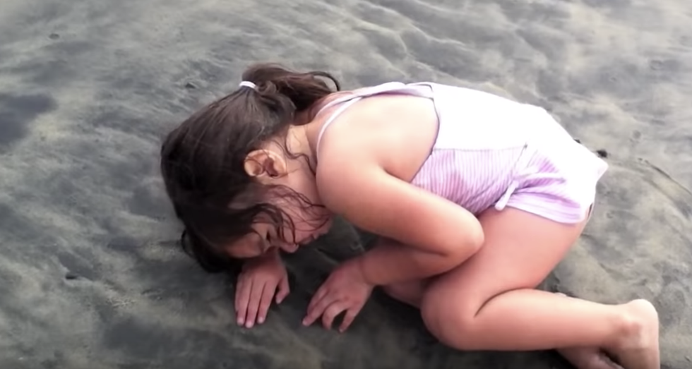 Little Girl Deciding To Nap On The Sand