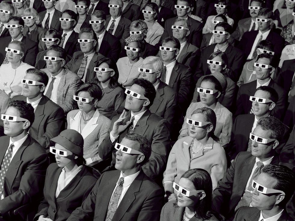 Lots of people sat on the cinema wearing 3D glasses