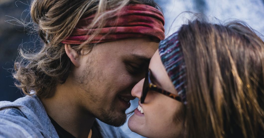 Man and woman smiling and almost kissing 
