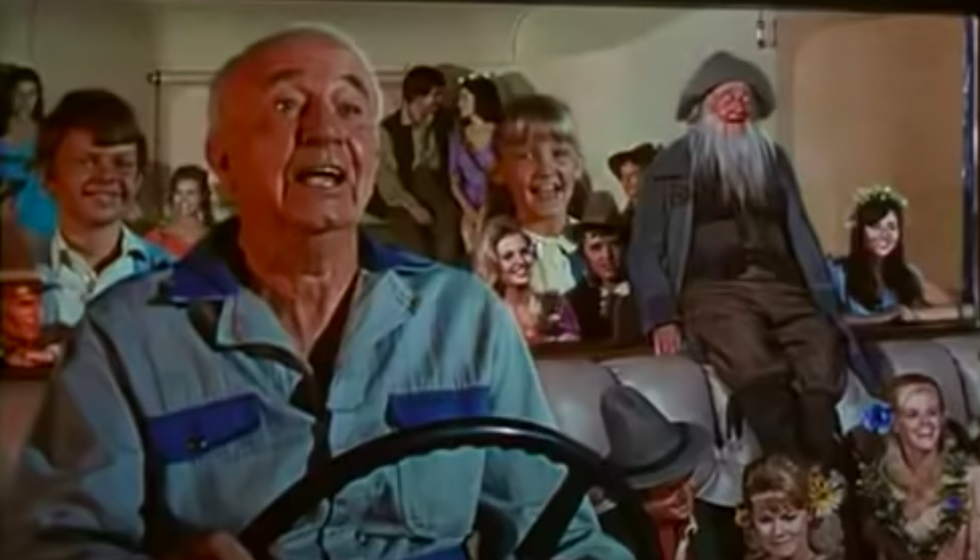 Man driving bus full of gnomes and children