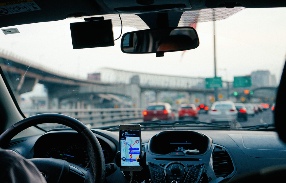 man driving vehicle with GPS system turned on