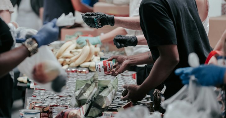 man in black t-shirt holding coca cola bottle