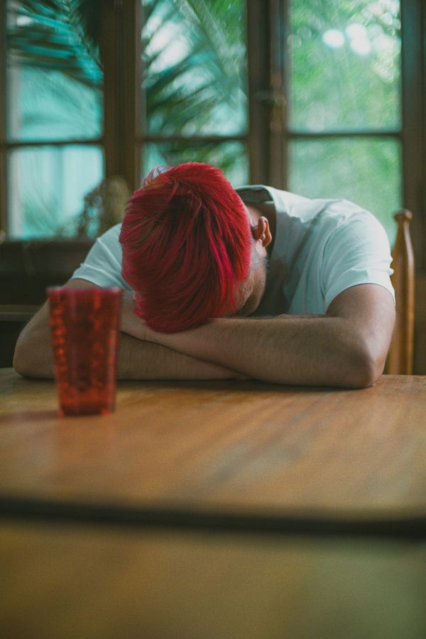 man in white t-shirt sitting at the table