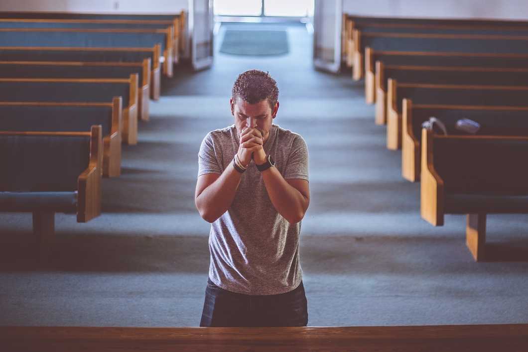 Man praying alone