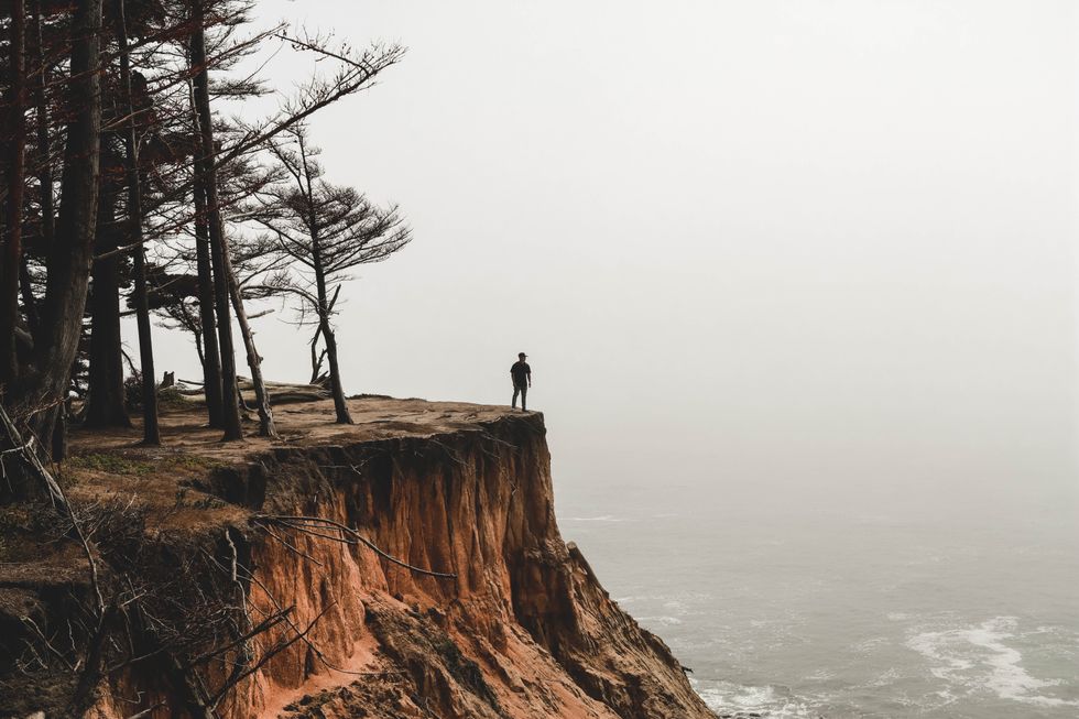 Man standing on the edge of a cliff