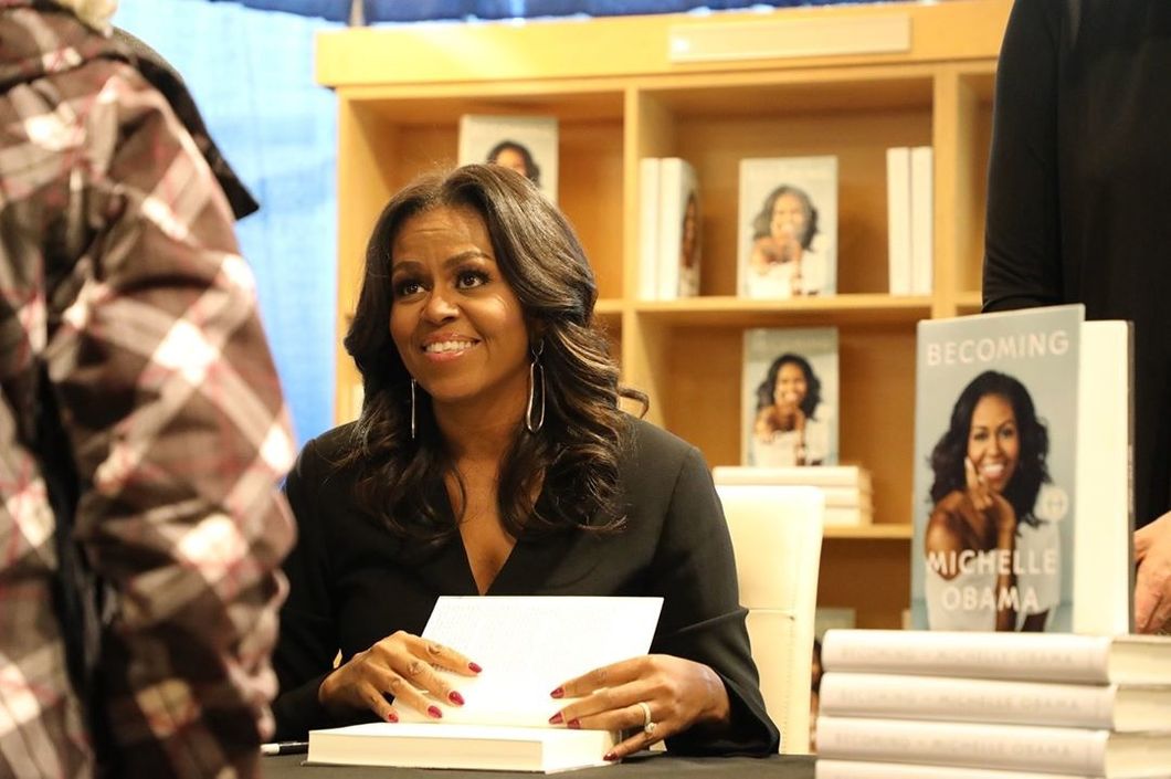 Michelle Obama signing her book "Becoming"