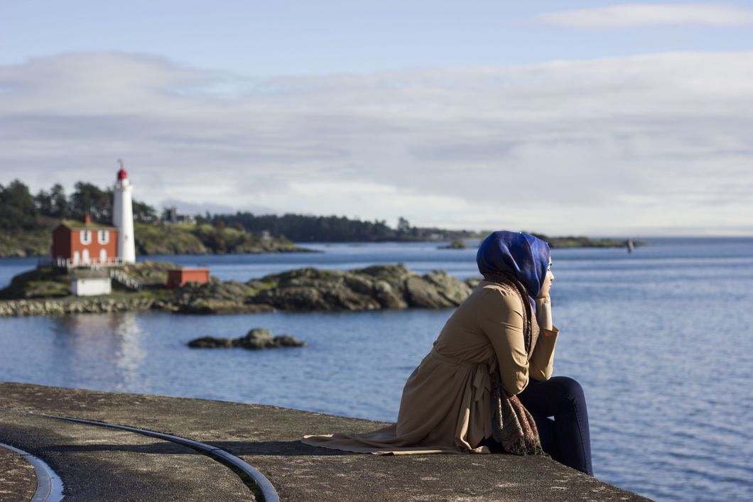 Muslim woman looking out into the ocean