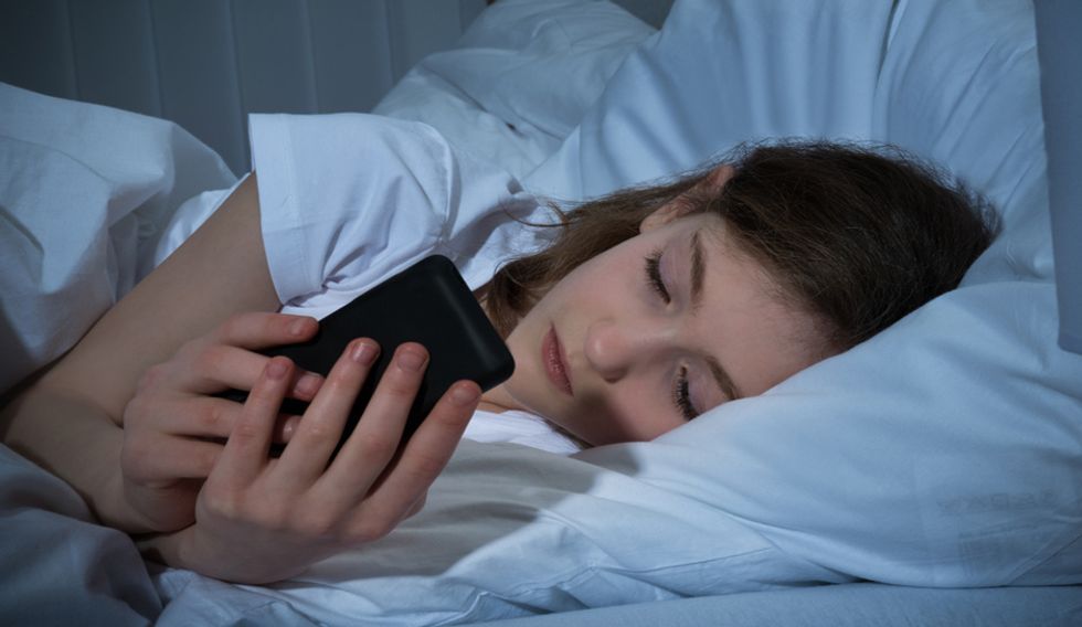 on phone in bed